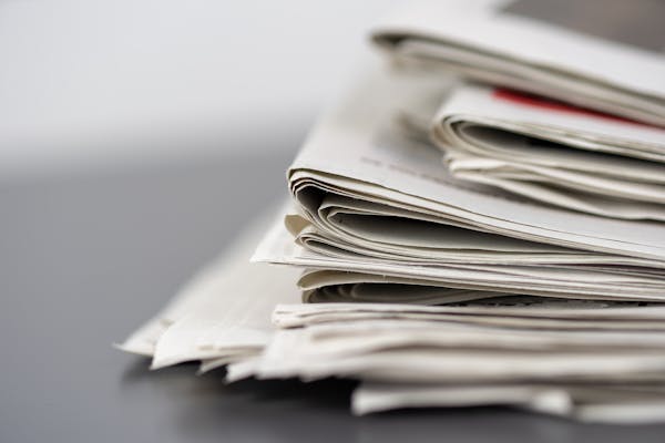Stacked newspapers on a table